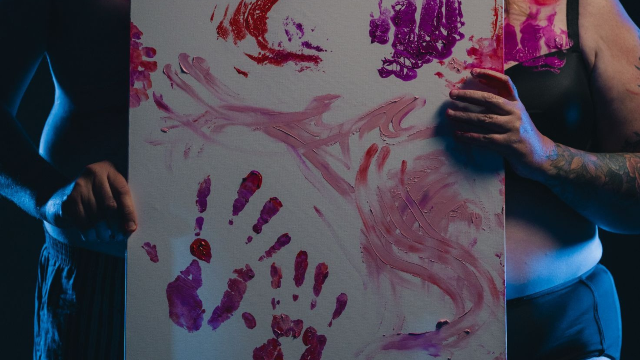 Couple holds a Finger painting artwork between them